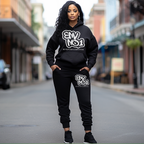 Woman wearing a black hoodie and pants with 'ENVNO1' branding on a city street.