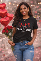Woman wearing a black t-shirt with 'LOVE ON PURPOSE' text, holding red roses, with a heart-themed background.
