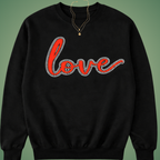 Black sweatshirt with 'love' in red text on a green background with rhinestone outline