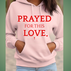 Pink hoodie with 'PRAYED FOR THIS LOVE' text on a green background